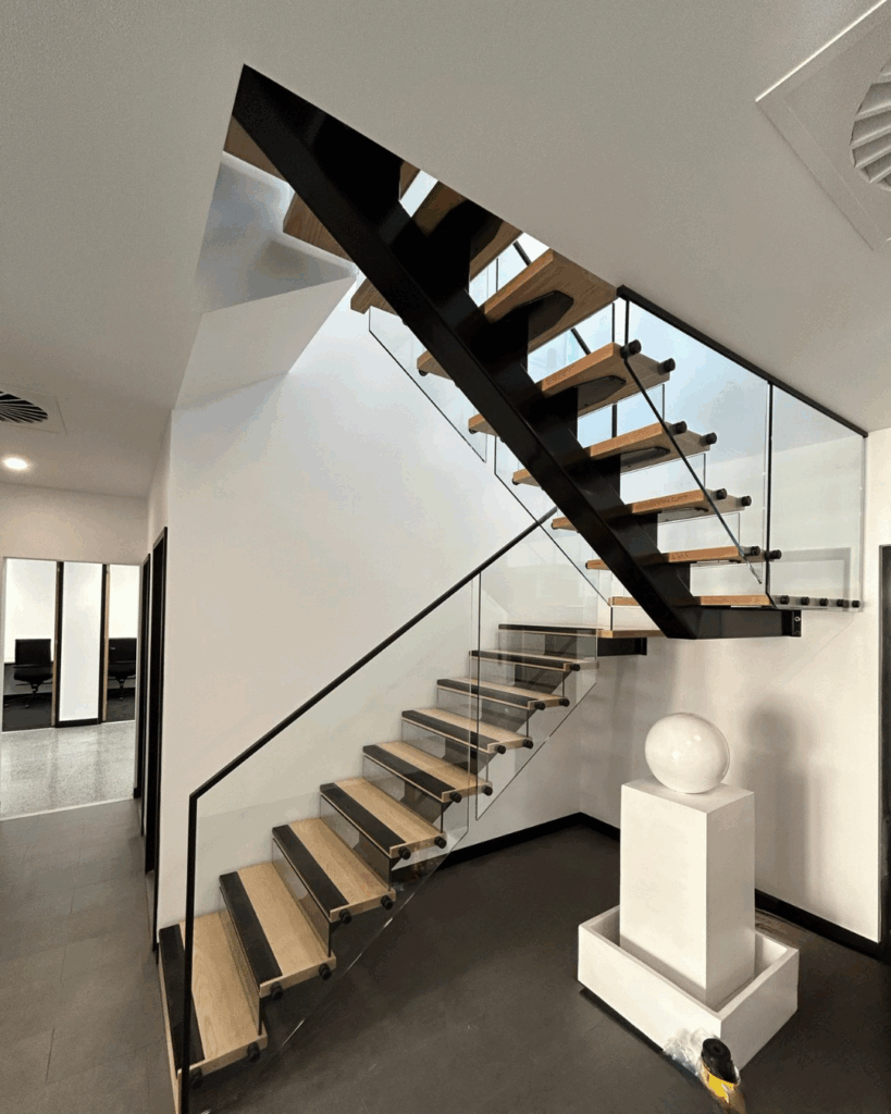 Stair with steel stringer, glass risers, timber treads and frameless glass balustrade