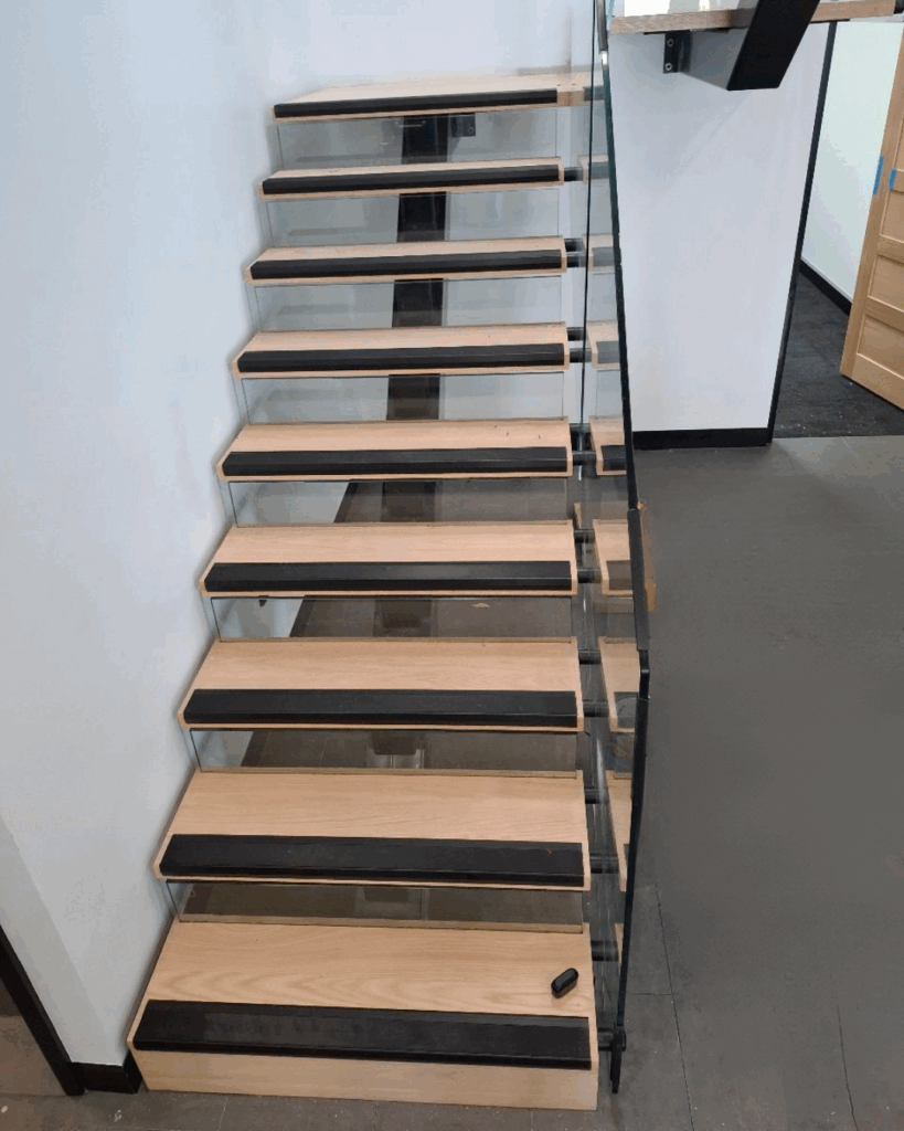 Stair with steel stringer, glass risers, timber treads and frameless glass balustrade