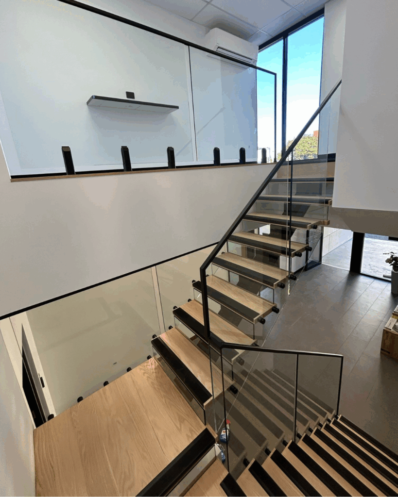 Stair with steel stringer, glass risers, timber treads and frameless glass balustrade