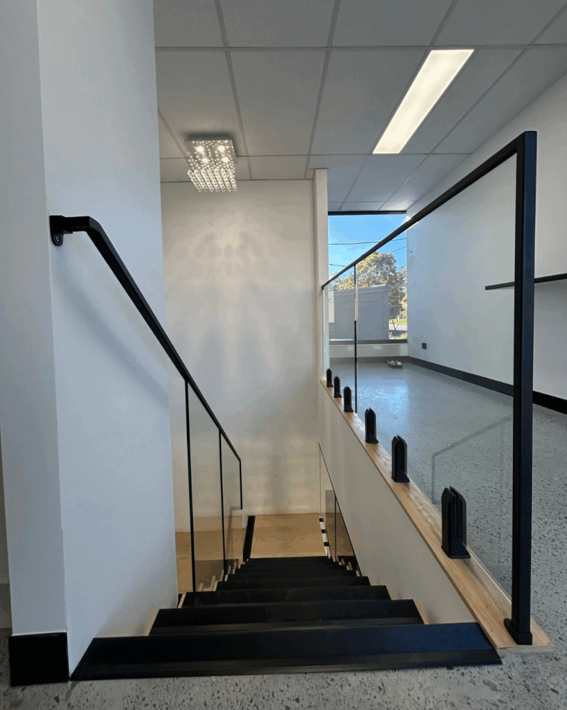 Stair with steel stringer, glass risers, timber treads and frameless glass balustrade