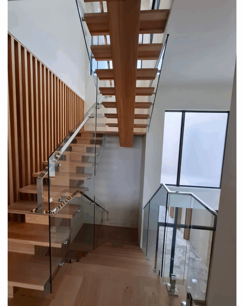 Open stair with centre box stringer, frameless glass balustrade, timber screen and stainless steel handrail