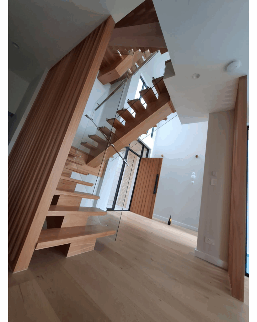 Open stair with centre box stringer, frameless glass balustrade, timber screen and stainless steel handrail