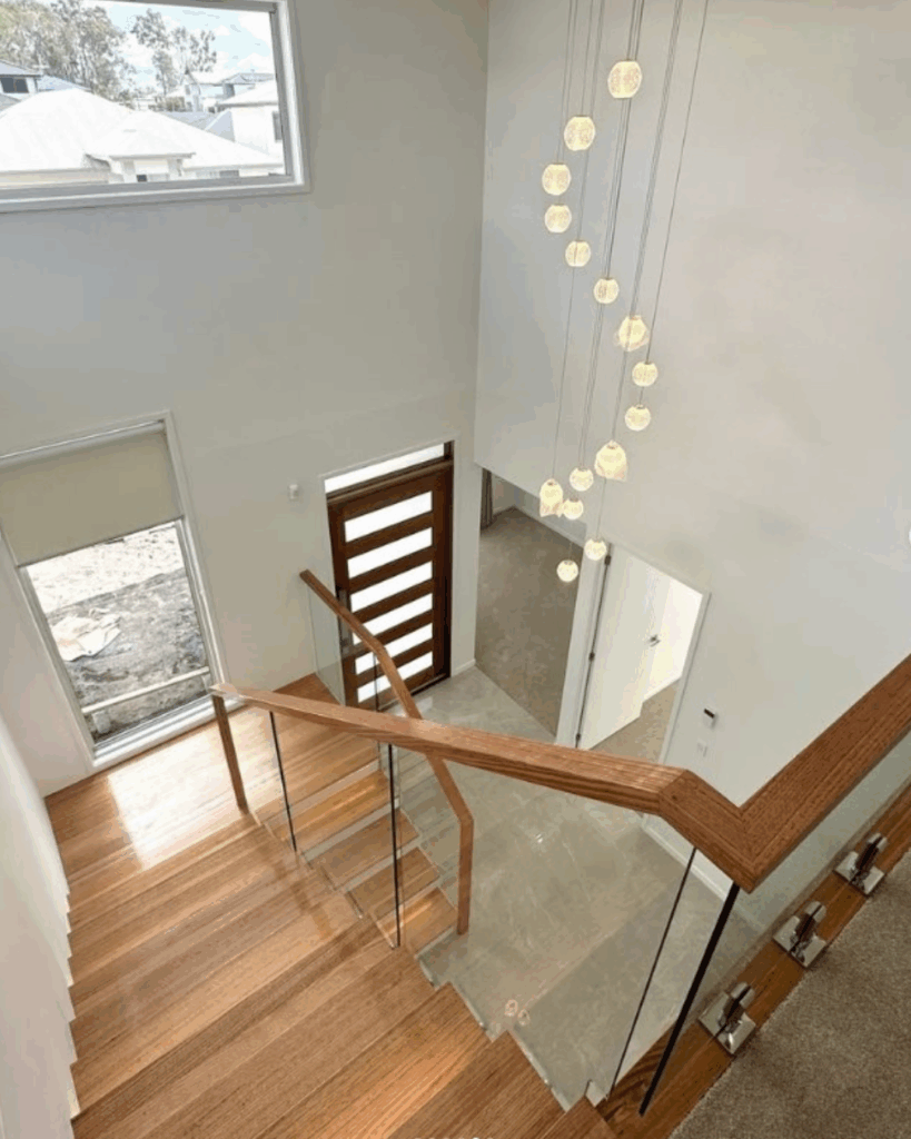 Stair with frameless glass balustrade and front door