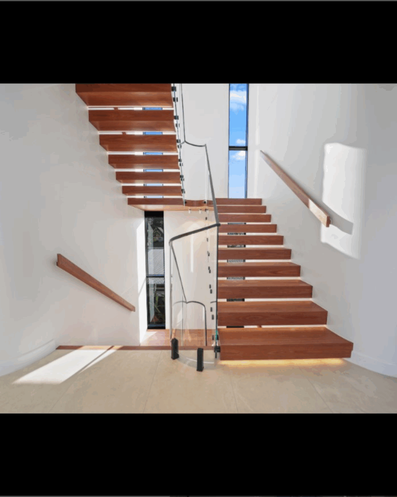Open cantelevered stair with curved frameless glass balustrade