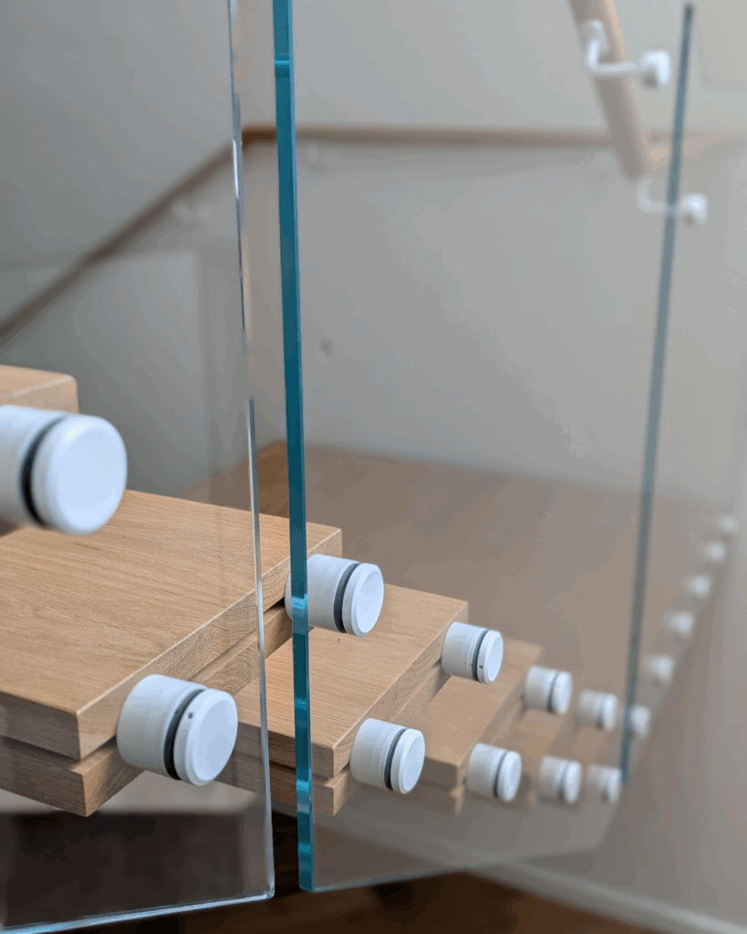 Centre mono steel stringer stair with American Oak treads, frameless glass balustrade and timber wall rail