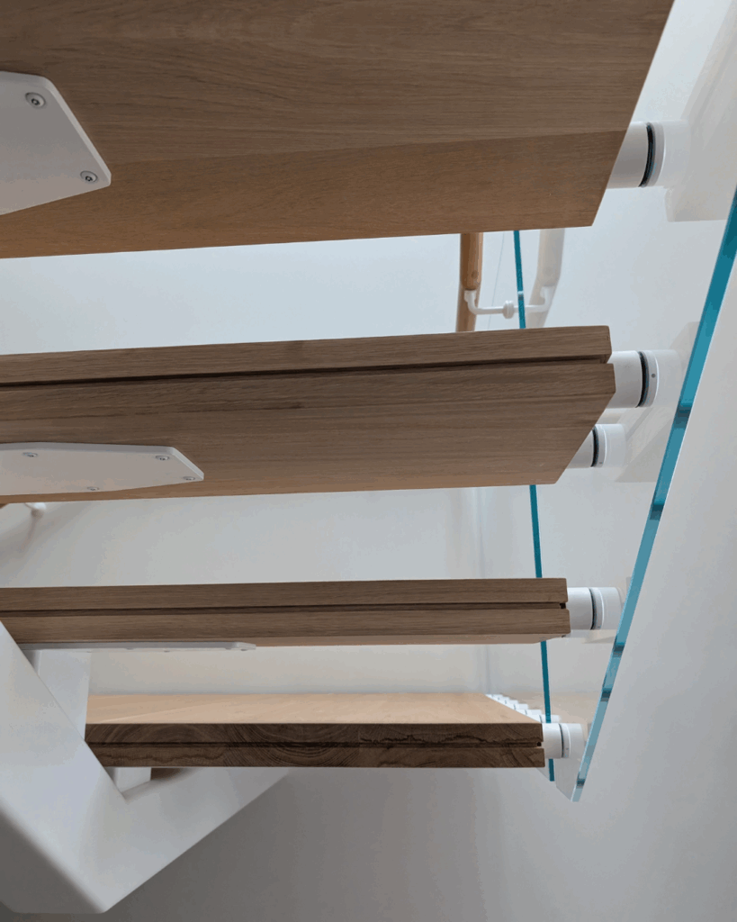 Centre mono steel stringer stair with American Oak treads, frameless glass balustrade and timber wall rail