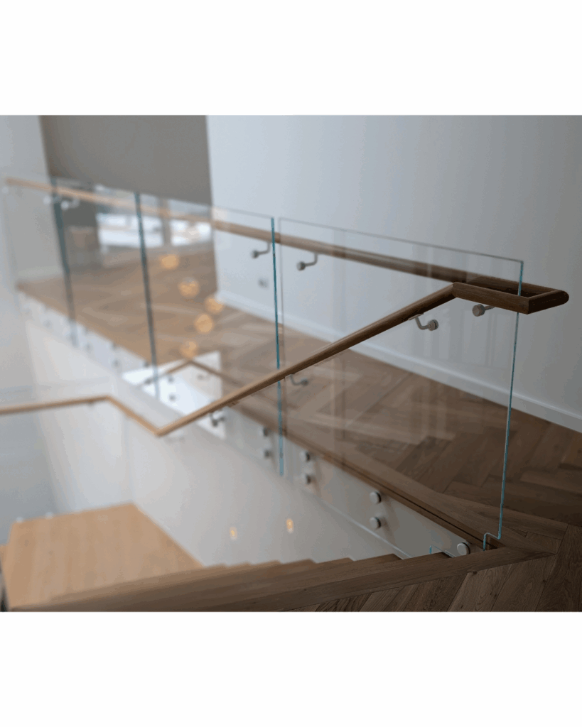 Centre mono steel stringer stair with American Oak treads, frameless glass balustrade and timber wall rail