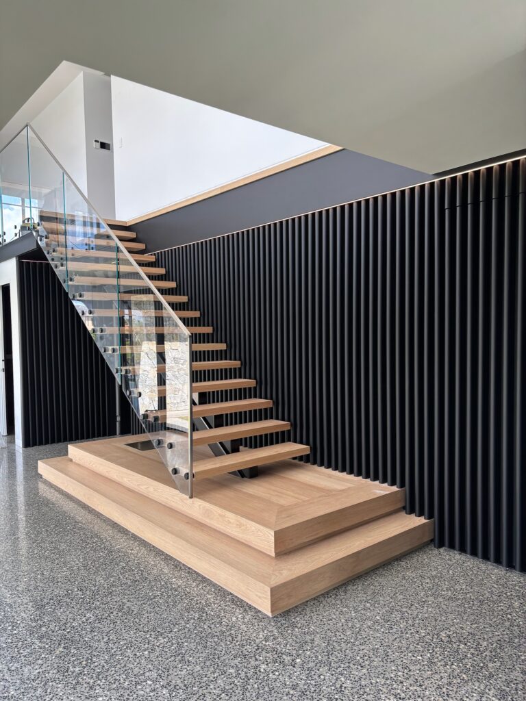 steel mono stringer stair with Pacific Oak treads and frameless glass balustrade