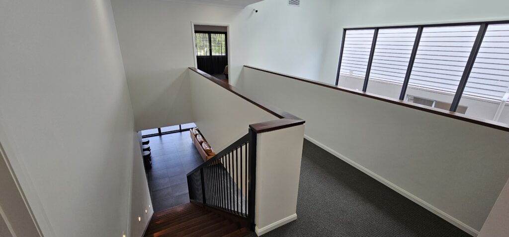 Open stair with powdercoated balustrade and capping on half wall