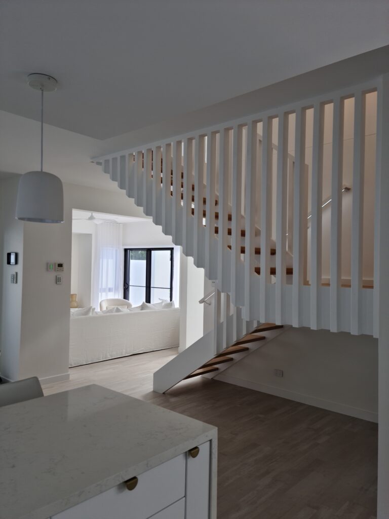 Side view of open staircase with timber screen.