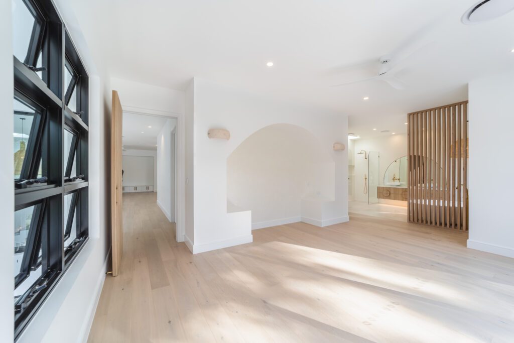 View of bedroom with entrance to ensuite bathroom featuring a timber screen