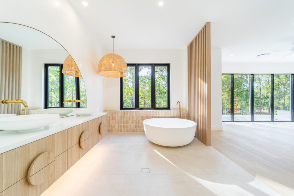 View of ensuite bathroom with vanity, bath and timber screen