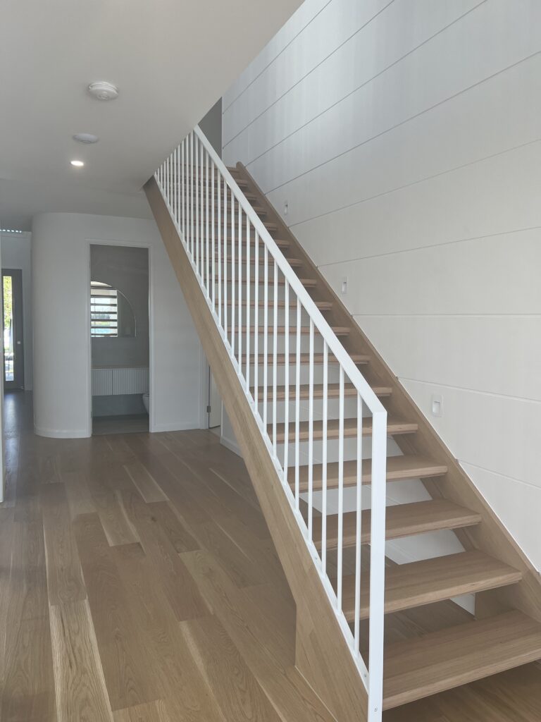 Open riser stair with white powdercoated balustrade.