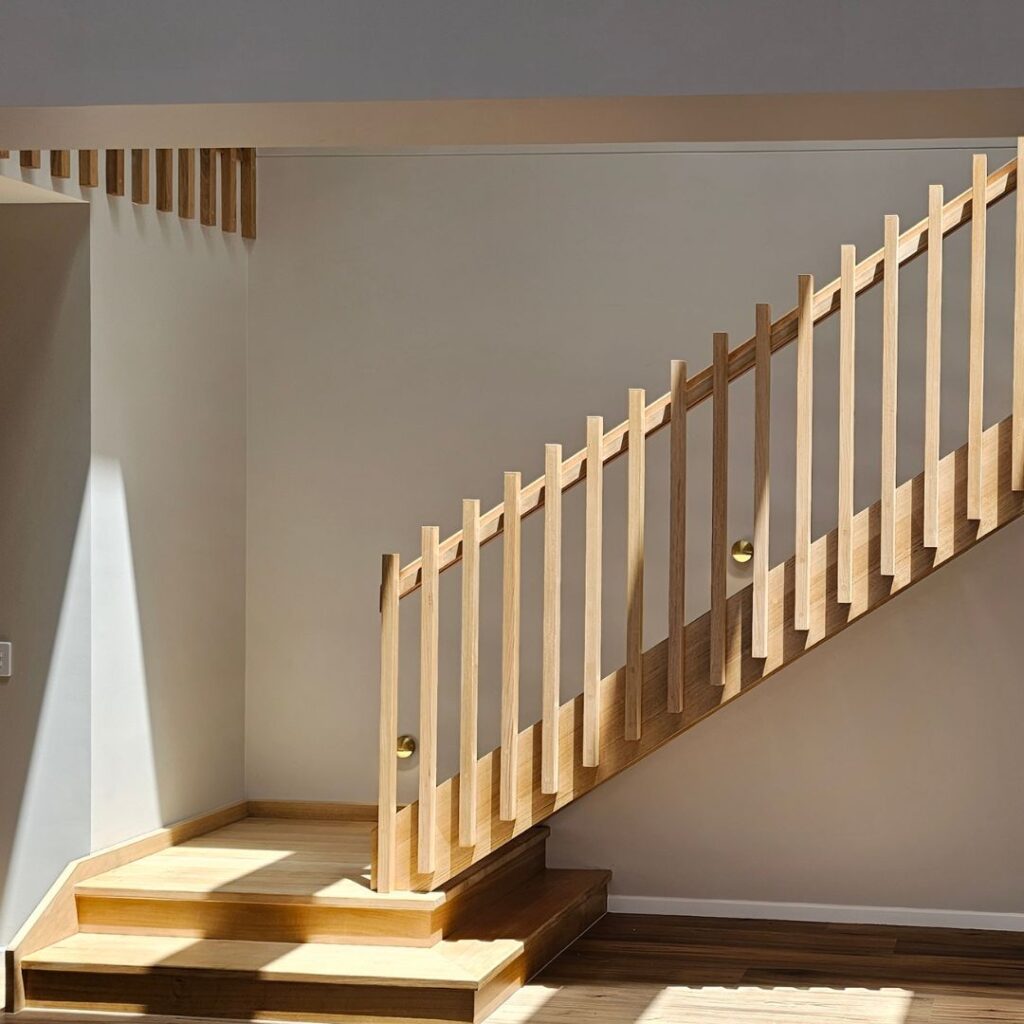 Open timber stair with platform stair and timber balustrade viewed from the side of the stair
