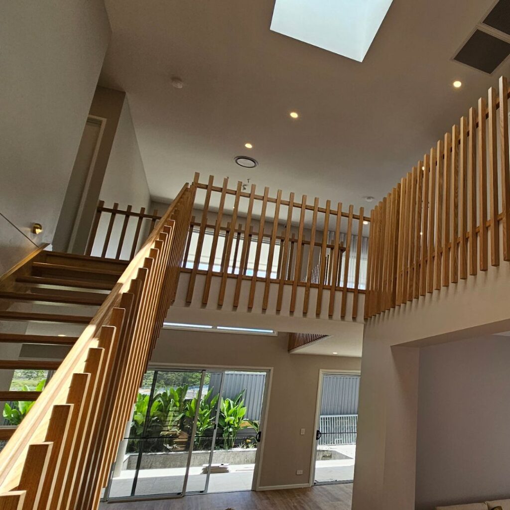 Open timber stair with timber balustrade viewed from the front of the stair