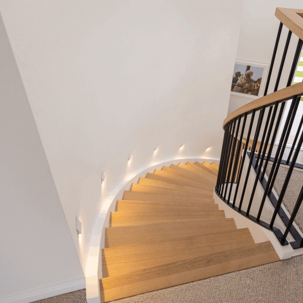 Curved timber stair with powder coated balustrade