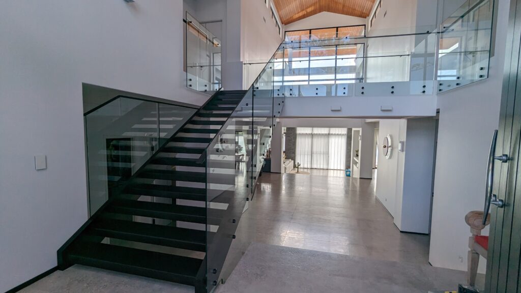 Open stair with frameless glass balustrade.
