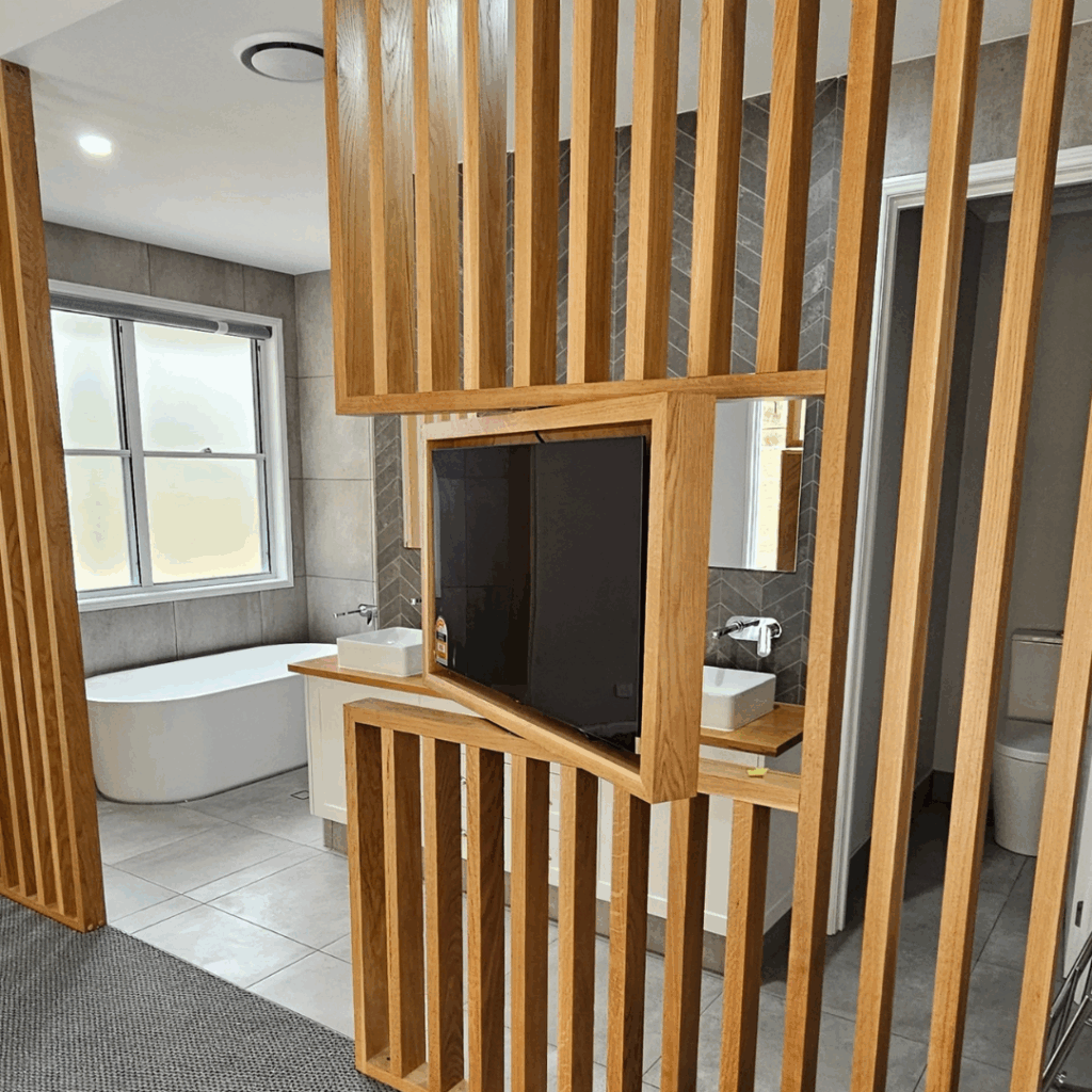 Room divider screen to bedroom and ensuite bathroom with feature television mount